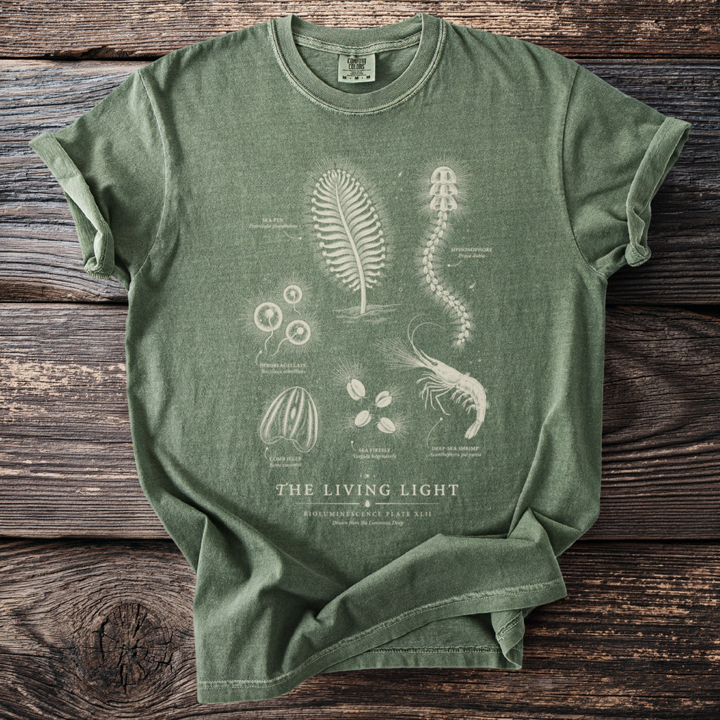 Green t-shirt with "The Living Light Bioluminescence Plate XLII" design of sea creatures and text.