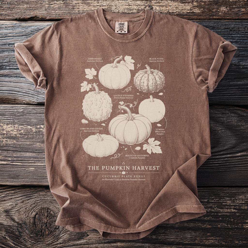 Brown t-shirt with illustration of various heirloom pumpkins titled "The Pumpkin Harvest".