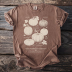 Brown t-shirt with illustration of various heirloom pumpkins titled "The Pumpkin Harvest".
