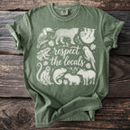 Green t-shirt with white line drawings of animals and text "respect the locals".