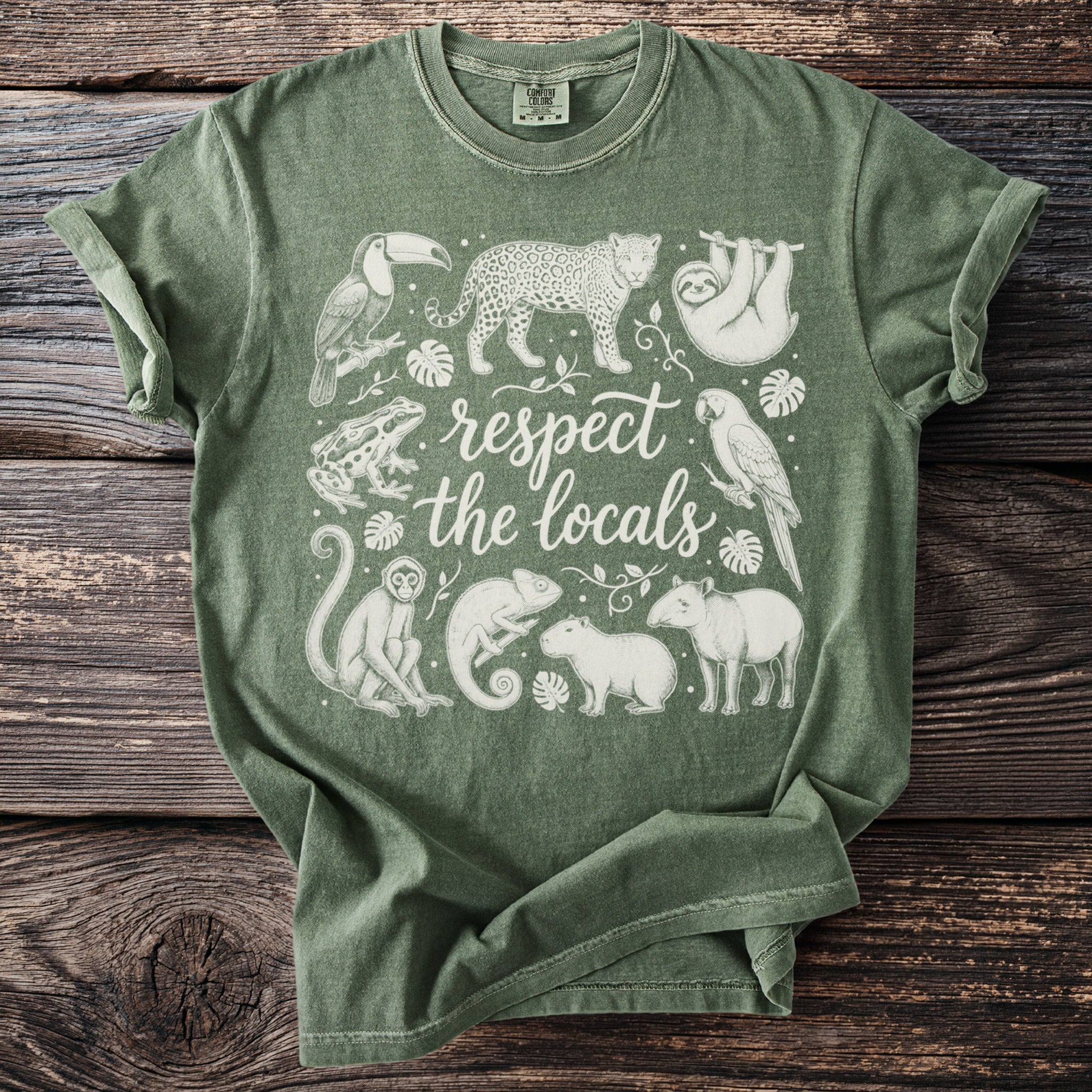 Green t-shirt with white line drawings of animals and text "respect the locals".
