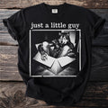 Black t-shirt with "just a little guy" text over wolf in a box graphic.