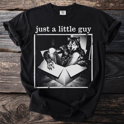 Black t-shirt with "just a little guy" text over wolf in a box graphic.