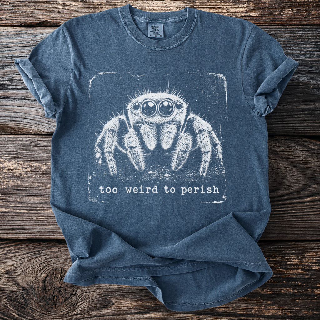 Blue t-shirt with white jumping spider graphic and text "too weird to perish".