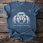 Blue t-shirt with white jumping spider graphic and text "too weird to perish".
