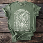 Green t-shirt with white graphic: "All Plants Are Edible Some Only Once" and skull.