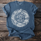 Blue t-shirt with white graphic of nature: alligator, turtle, frog, dragonflies, and heron.