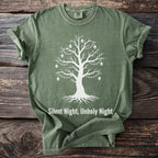 Green t-shirt with white tree graphic adorned with skulls and lights, reading "Silent Night, Unholy Night".