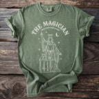 Green t-shirt with white line art of "The Magician" tarot card with occult symbolism.