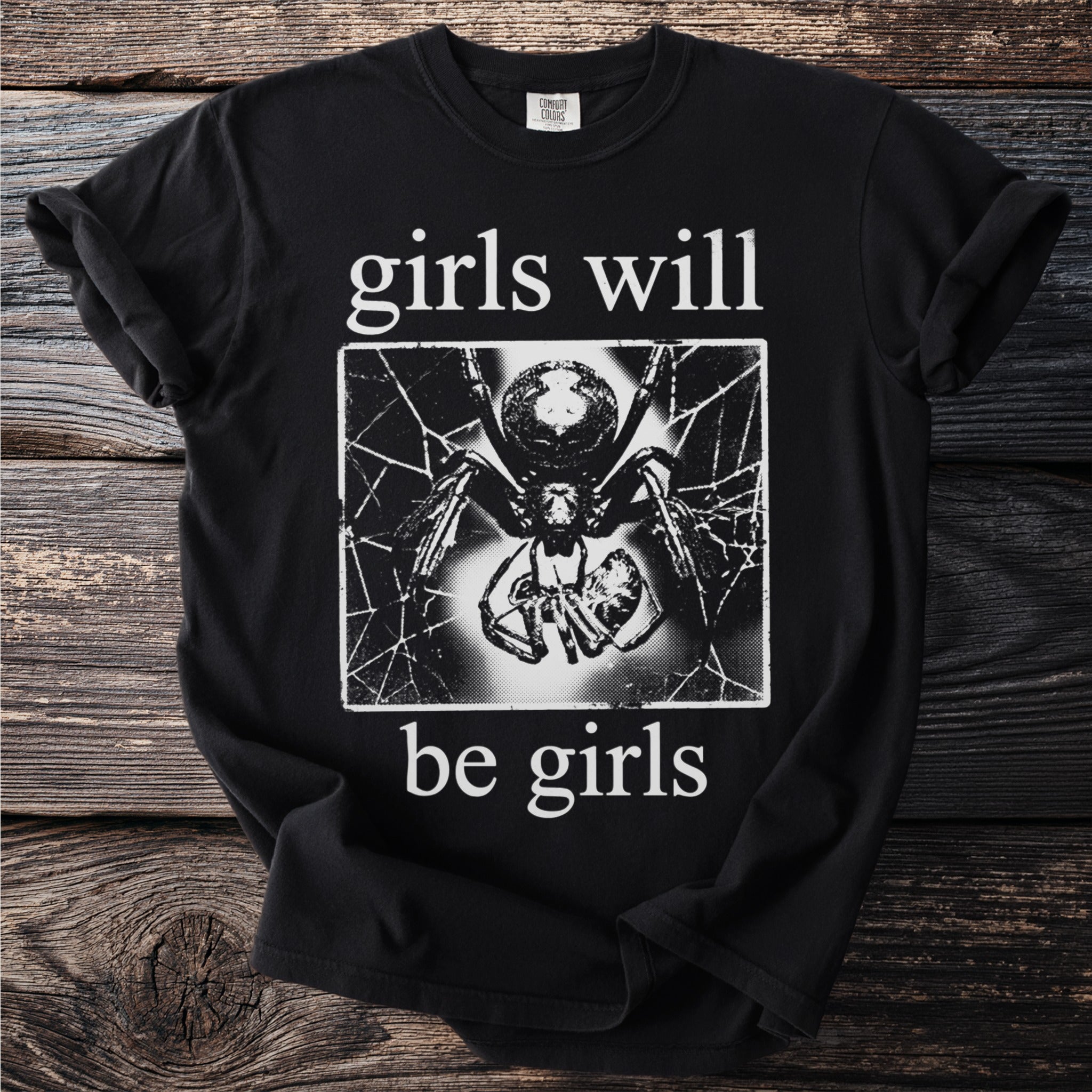 Black t-shirt with "girls will be girls" text and a spider graphic.