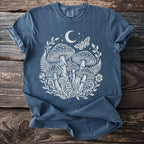 Blue t-shirt with white mushroom, moon, stars, and butterfly graphic.