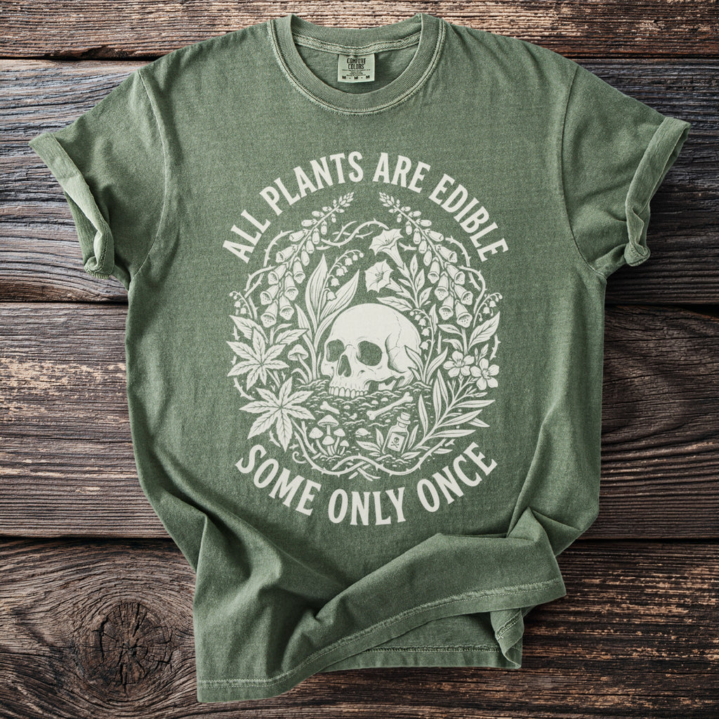 Green t-shirt with skull and plants graphic and text "All Plants Are Edible Some Only Once".