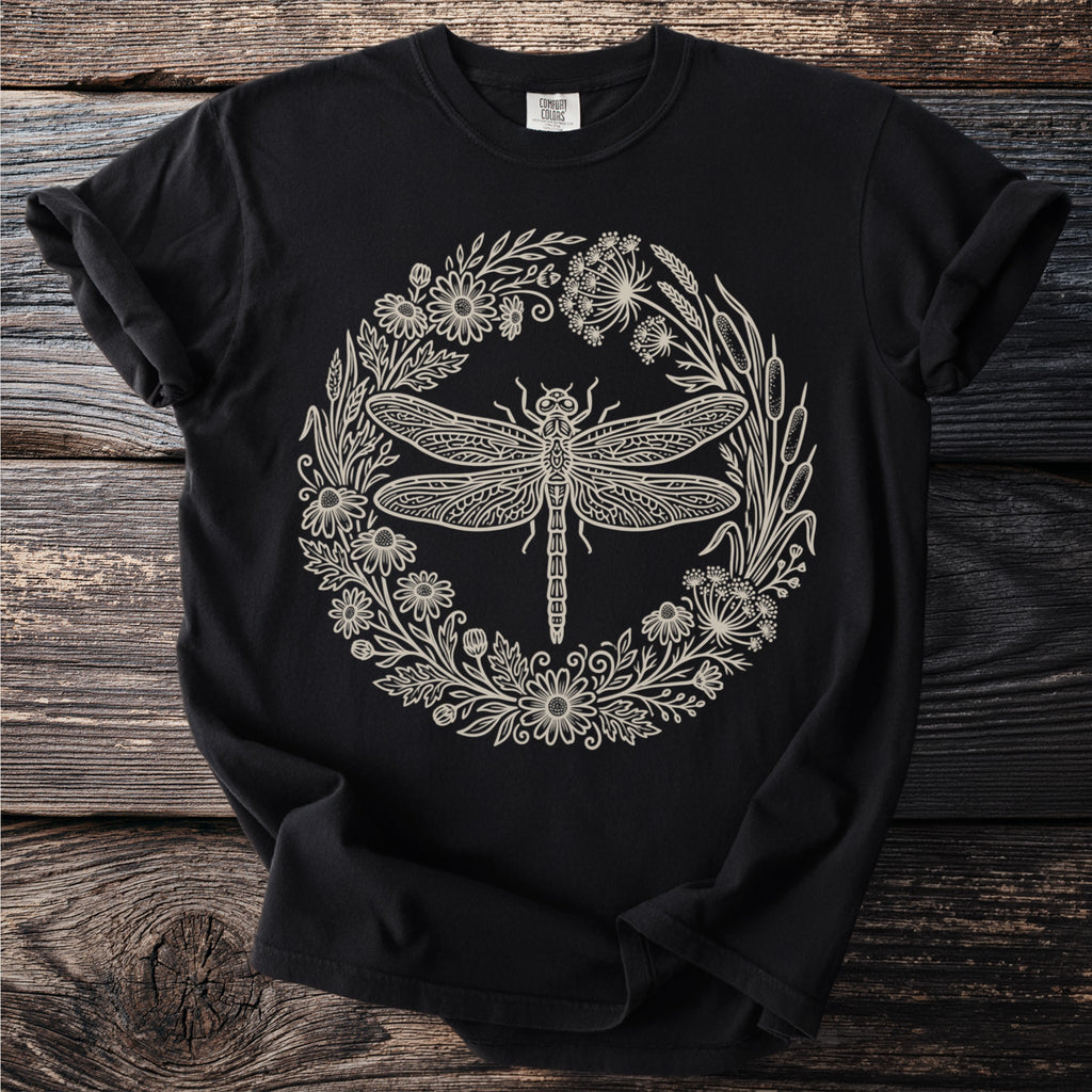 Black t-shirt with detailed cream dragonfly and floral wreath design.