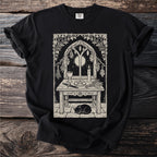 Black t-shirt featuring a gothic altar scene with a cat and moon.