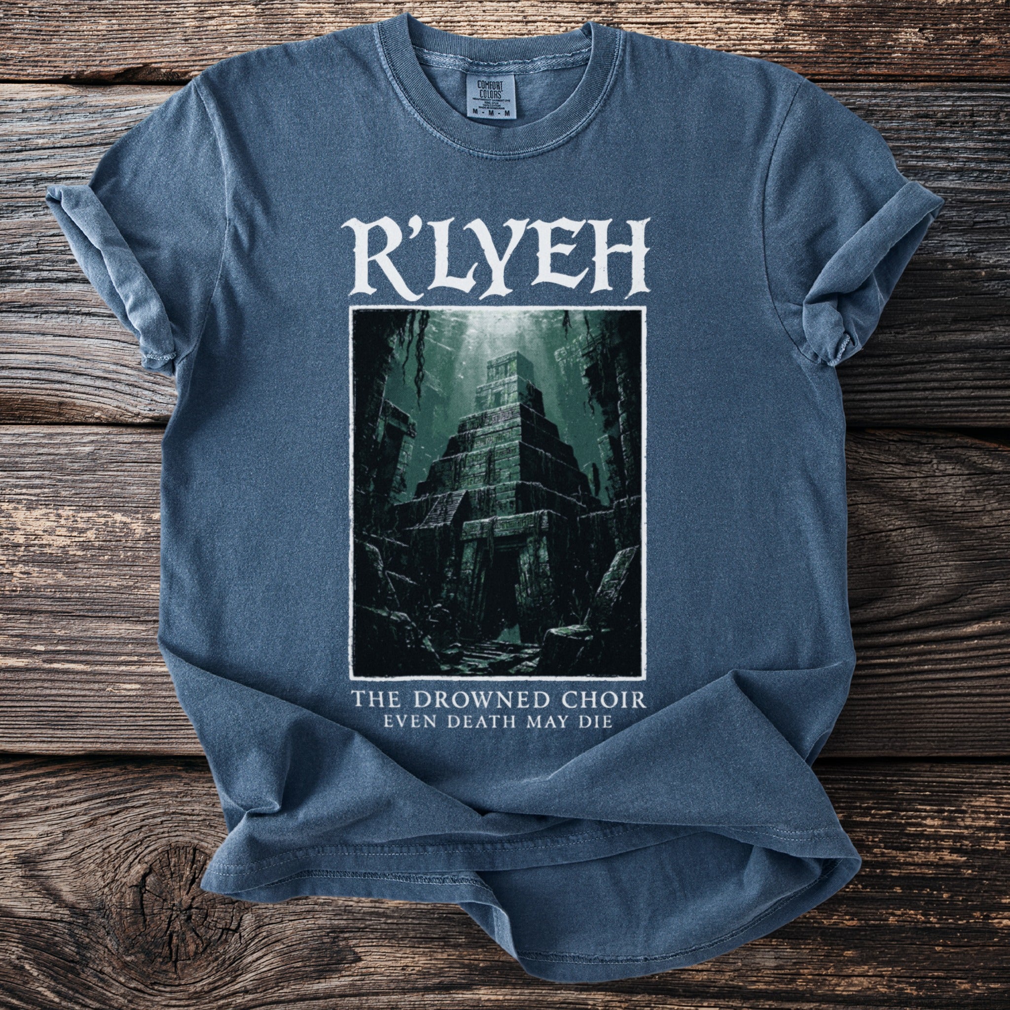 Blue t-shirt with R'lyeh graphic and text "The Drowned Choir Even Death May Die".