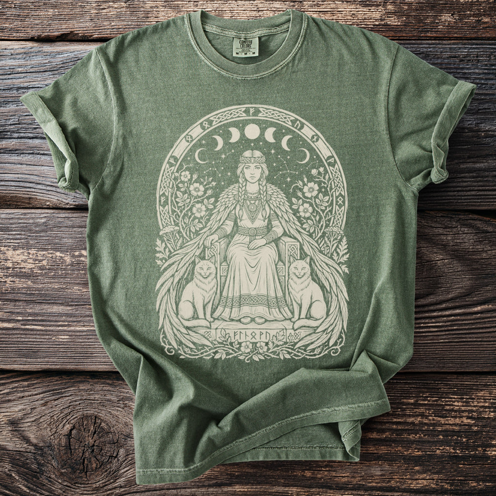 Green t-shirt with a seated woman, cats, moon phases, and runes design.