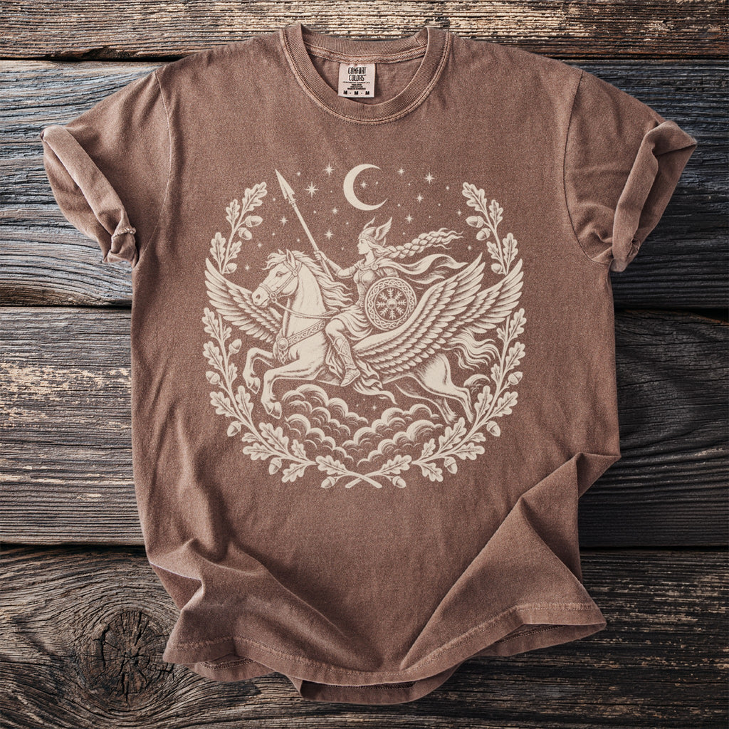 Brown t-shirt with cream graphic of Valkyrie riding Pegasus within oak leaf wreath and moon.