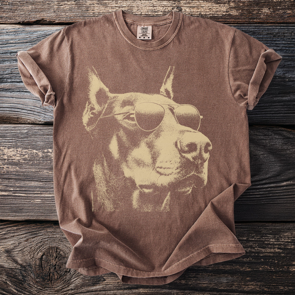 Brown t-shirt featuring a graphic of a Doberman wearing sunglasses.