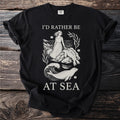 Black t-shirt with text "I'D RATHER BE AT SEA" and illustration of woman and seals.