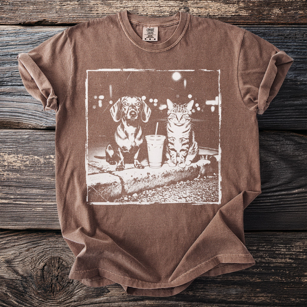 Brown t-shirt with graphic of a Dachshund and cat sitting next to a drink.
