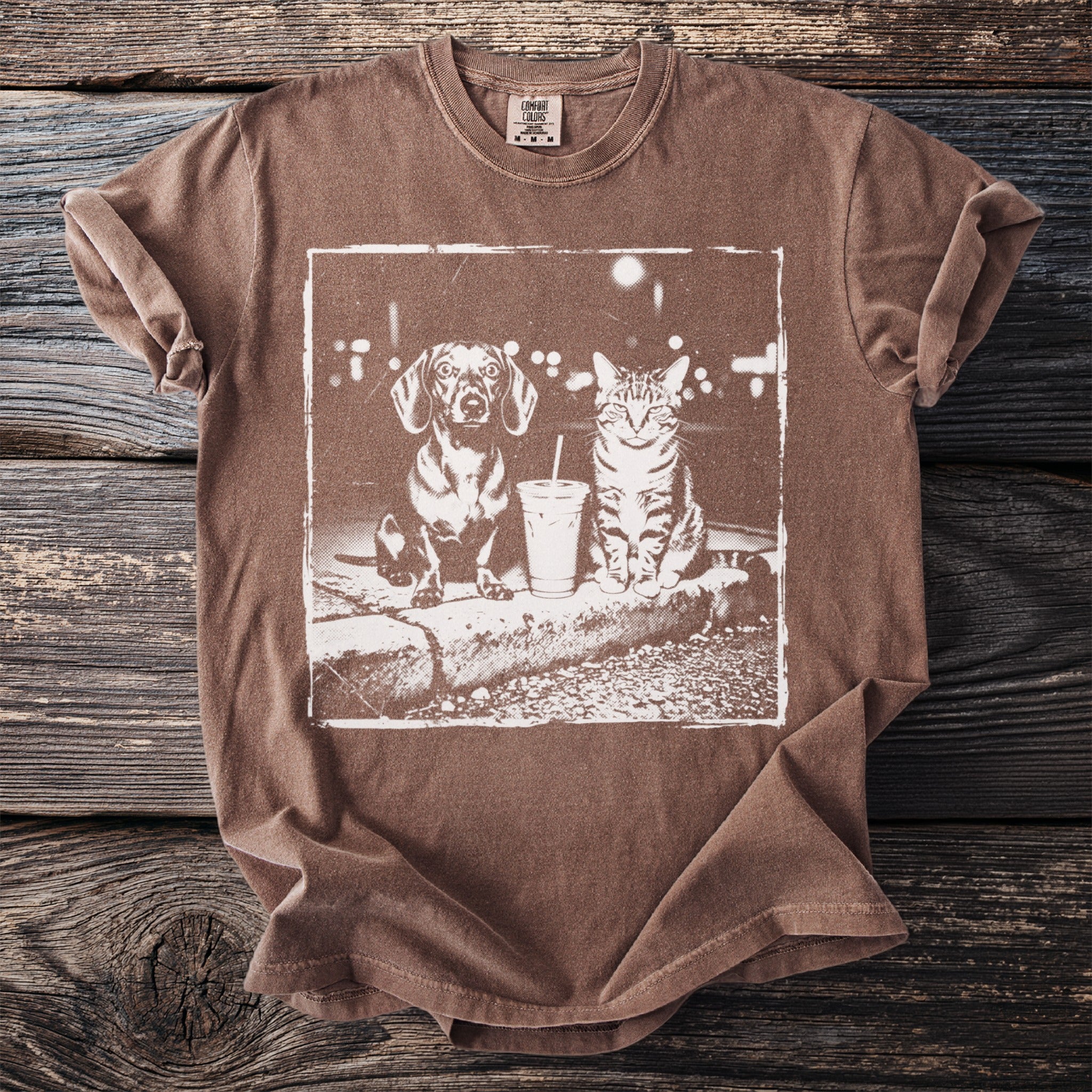 Brown t-shirt with graphic of a Dachshund and cat sitting next to a drink.