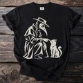 Plague doctor in costume gently touches a sitting cat with his finger.
