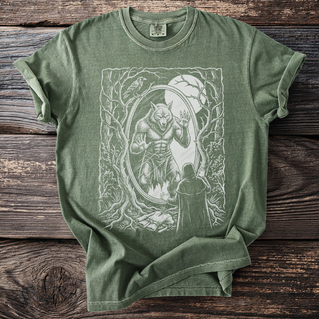 Green t-shirt with a white graphic of a werewolf in a mirror and a cloaked figure.
