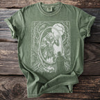 Green t-shirt with a white graphic of a werewolf in a mirror and a cloaked figure.