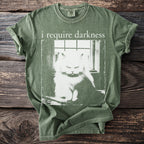 Green t-shirt with white graphic of a stern cat and text "i require darkness".