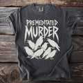 Dark t-shirt with white graphic of "PREMEDITATED MURDER" text and seven ravens.