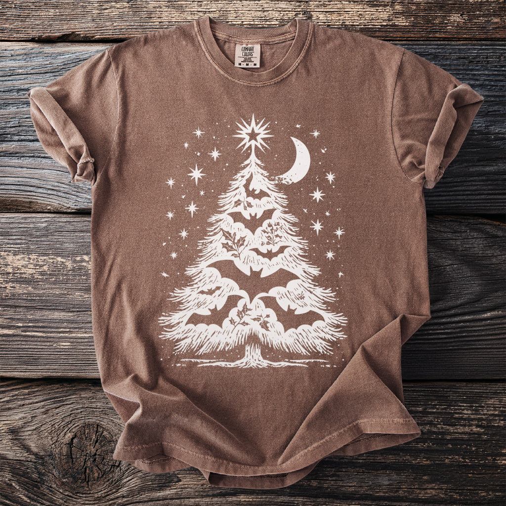 Brown t-shirt with white graphic of a bat and moon-decorated Christmas tree.