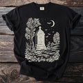 Black t-shirt with a graveyard scene featuring a tombstone, moon, bats, and trees.