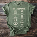 Green t-shirt with "Witch Symbols" and depictions including spiral, ankh, crescent moon, eye, circle, pentacle, triple moon, and knot.