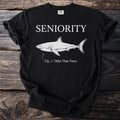 Black t-shirt with "SENIORITY" above a shark labeled "Fig. 1: Older Than Trees."