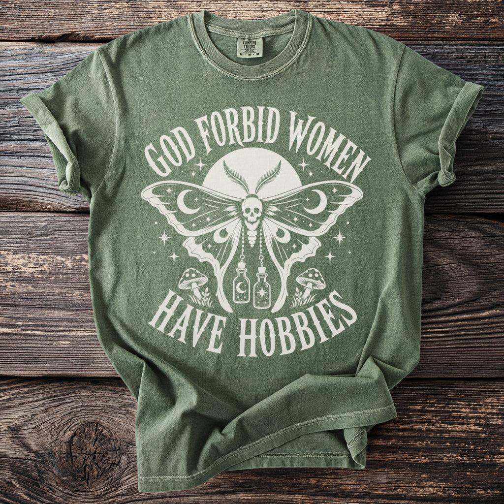 Green t-shirt with white graphic text and design of a moth with skull head.