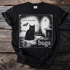 Black t-shirt with graphic featuring a black cat, moth, spider, and text "you're not alone there are bugs".