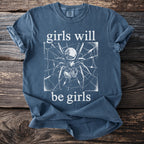Blue t-shirt with a white spider graphic and text "girls will be girls".