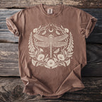 Brown t-shirt with cream colored dragonfly, moon, stars, and floral graphic.