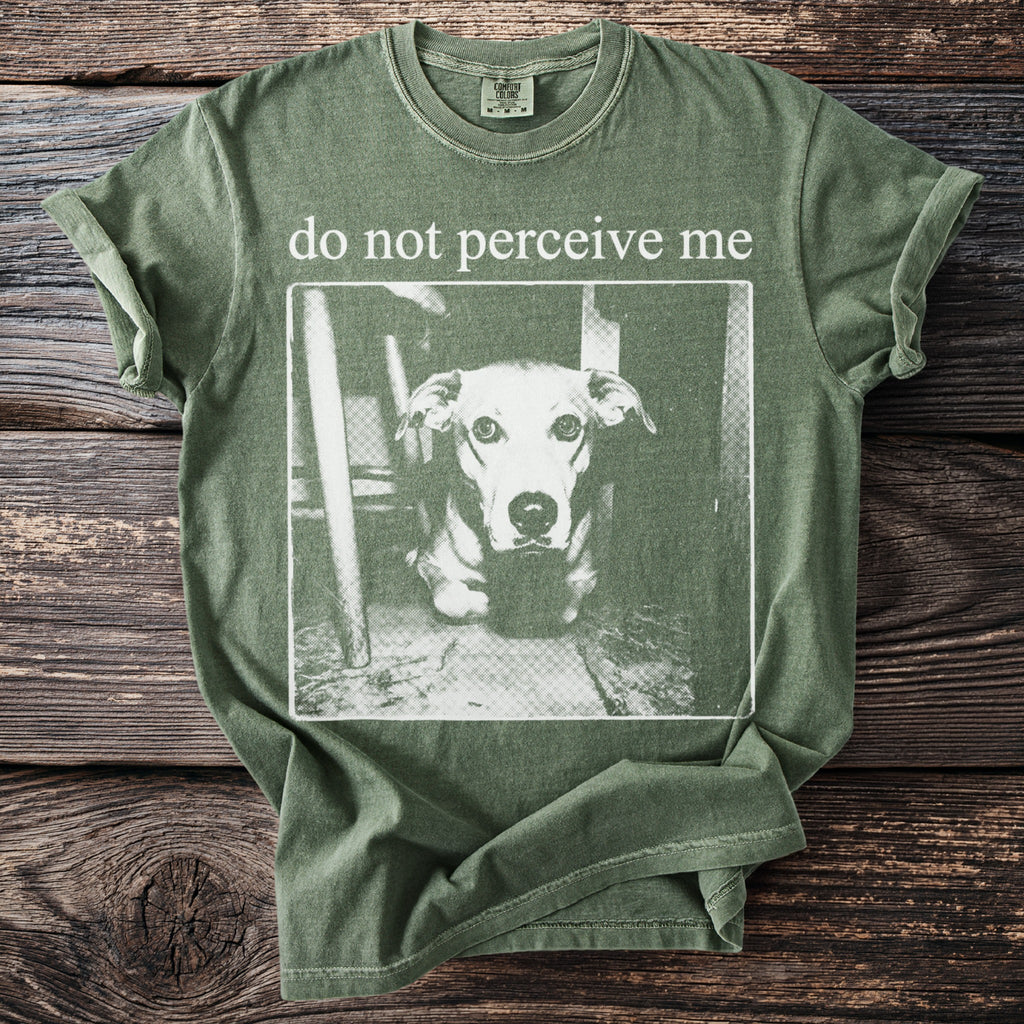Green t-shirt with a graphic of a dog and text "do not perceive me".