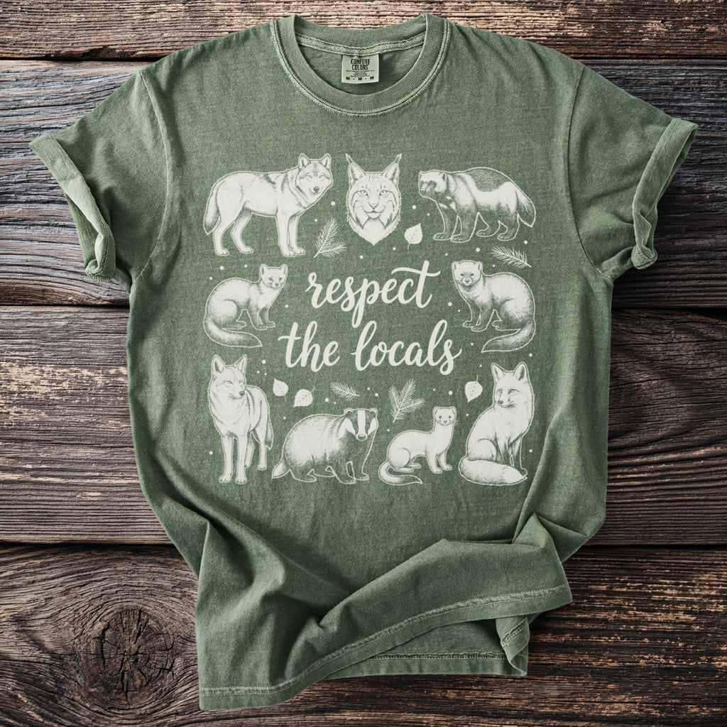 Green t-shirt with white nature-themed illustration and text.