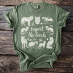 Green t-shirt with white nature-themed illustration and text.