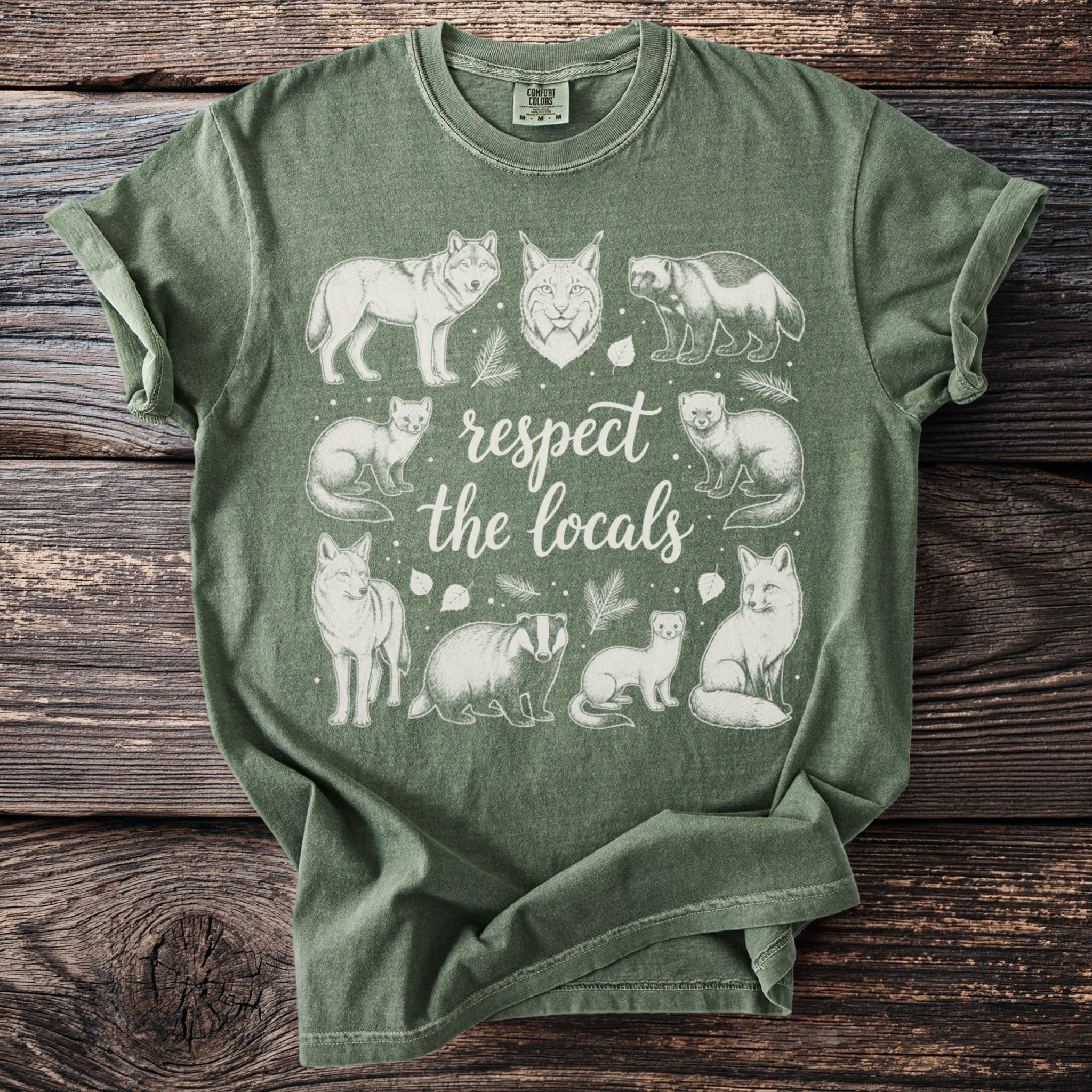 Green t-shirt with white nature-themed illustration and text.