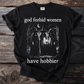 Black t-shirt with "god forbid women have hobbies" text and three witches in a forest.