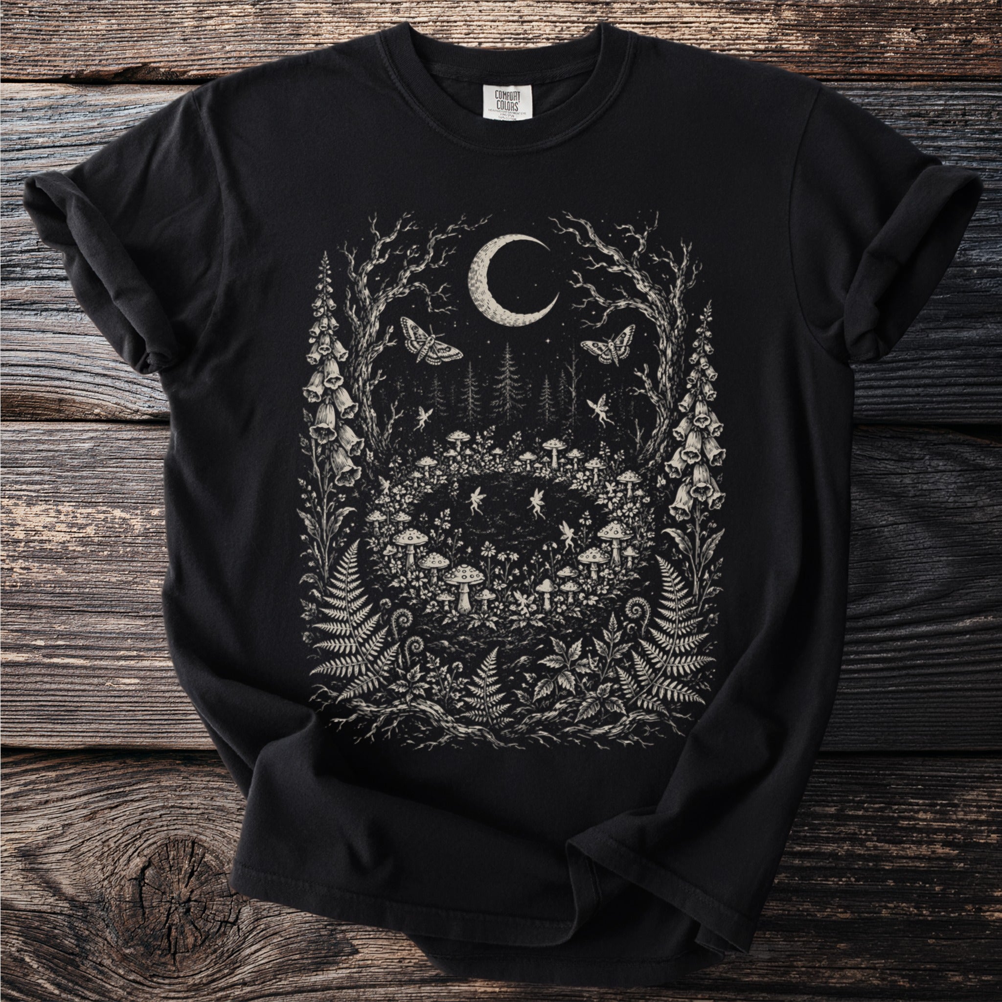 Black t-shirt with moon, moths, fairies and forest flora art print.