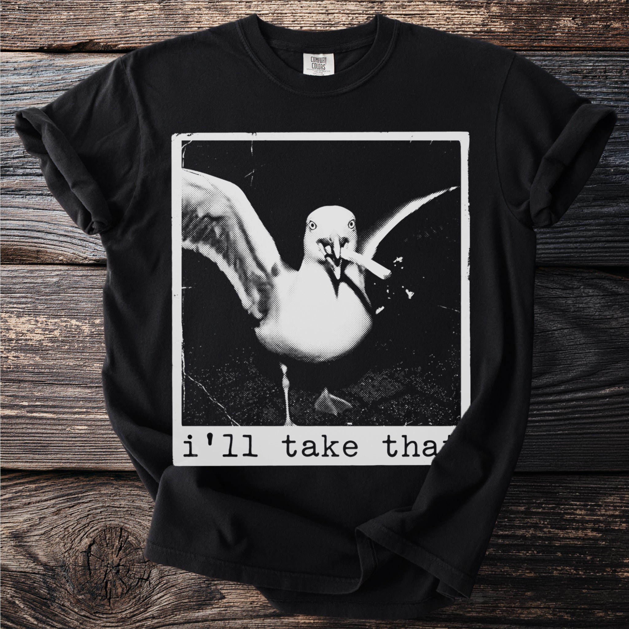 Black t-shirt with a distressed image of a seagull holding a cigarette and the text "i'll take tha".