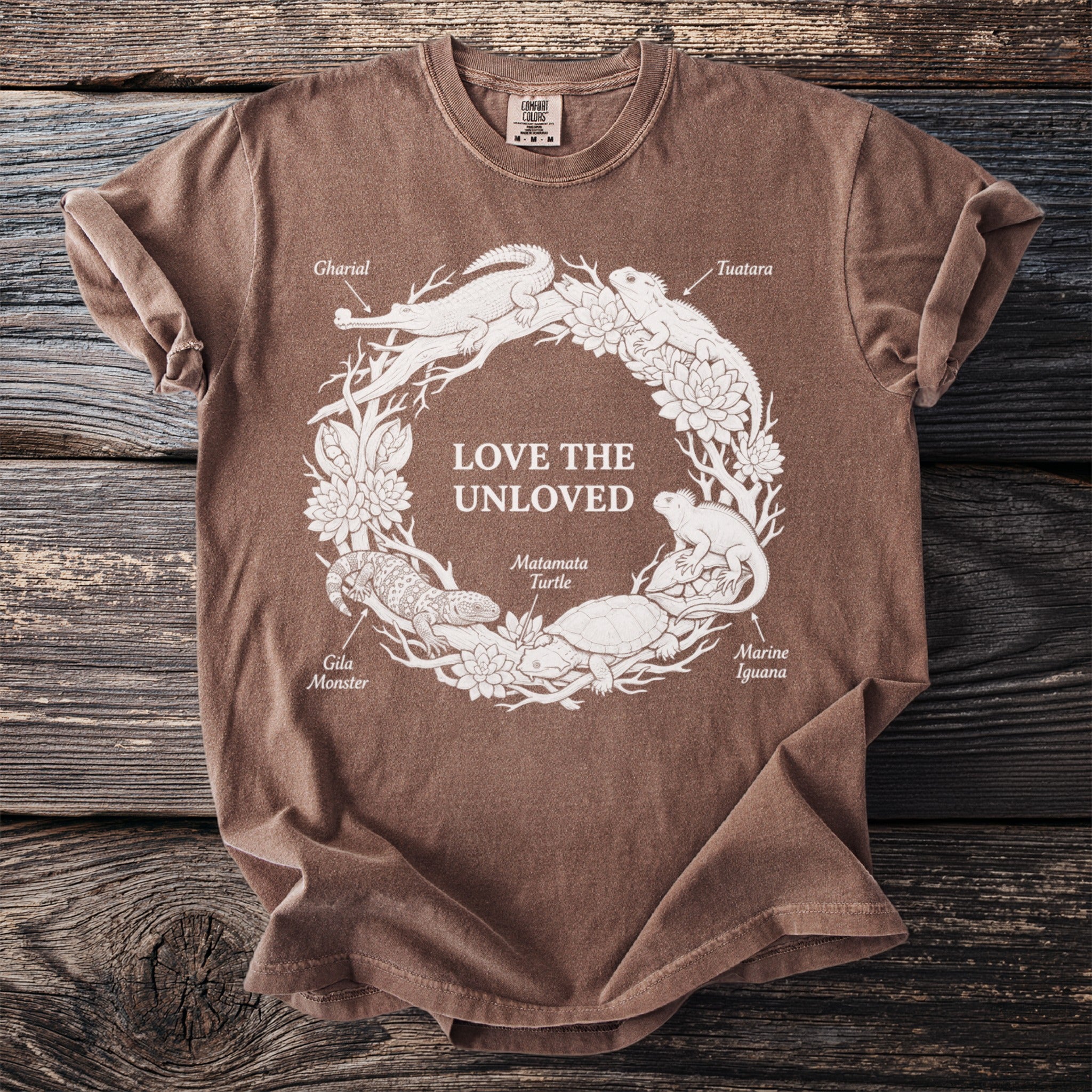 Brown t-shirt with "LOVE THE UNLOVED" and distressed illustrations of animals in a circle.