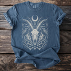 Blue t-shirt with a white graphic of a goat skull, ravens, and bones.