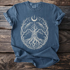 Blue t-shirt with a white graphic of a tree, ravens, eye, and moon symbols.