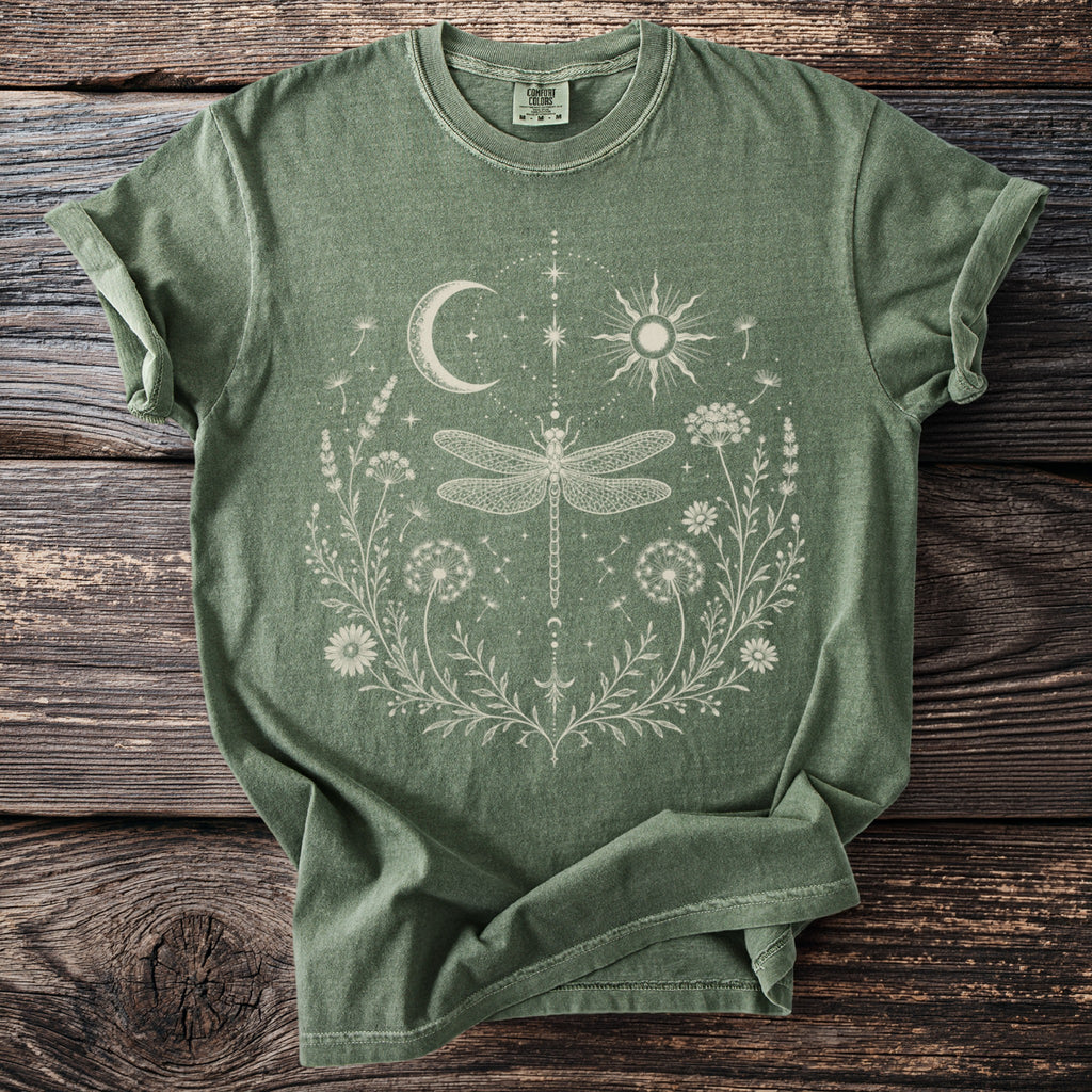 Green t-shirt with white dragonfly, sun, moon, and floral design.