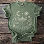 Green t-shirt with white dragonfly, sun, moon, and floral design.
